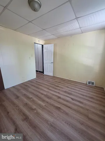 a view of a room with wooden floor