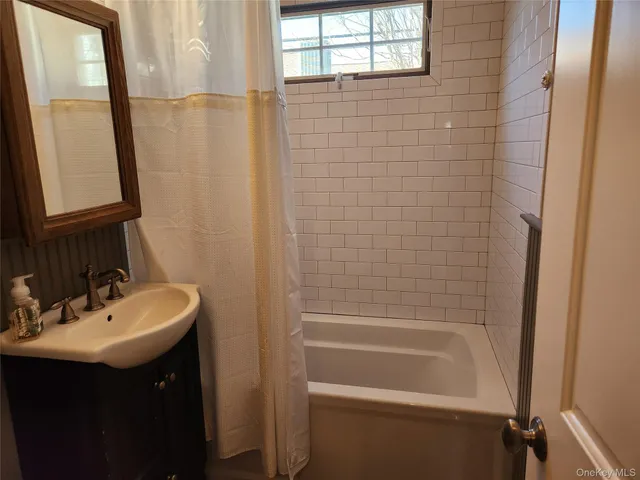 a bathroom with a sink a mirror and a shower