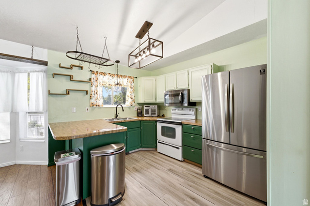 2475 Church Street Layton, UT 84040 - Photo 5 of 27 Kitchen featuring wood-finish flooring and two-tone cabinetry