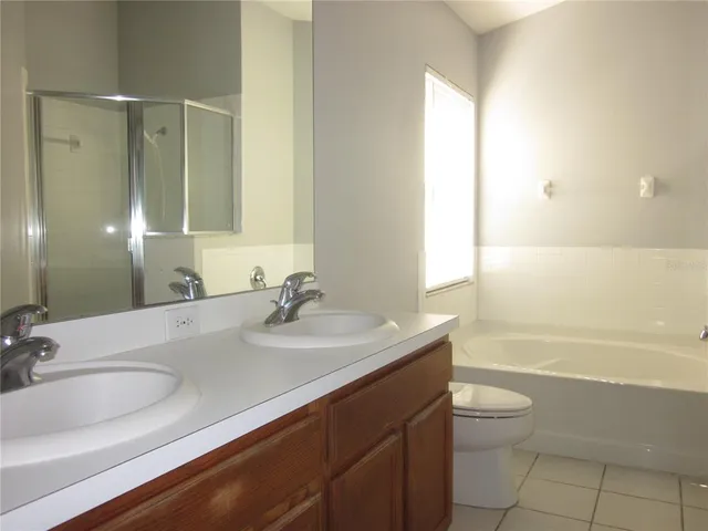 a bathroom with a sink a toilet and bathtub