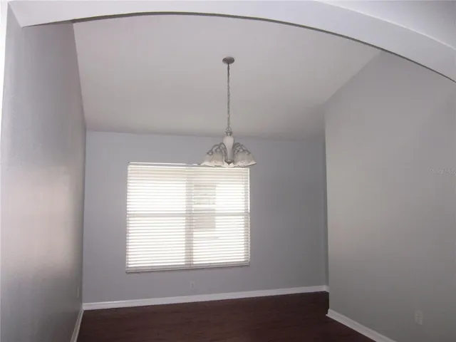a room with a window and ceiling fan
