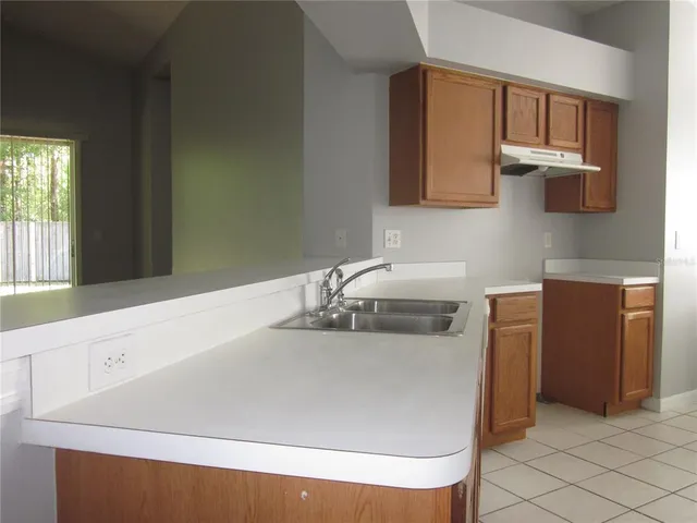 a kitchen with stainless steel appliances a sink and a refrigerator