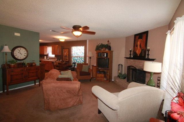 2525 110th Street Lubbock, TX 79423 - Photo 3 of 10 a living room with furniture a fireplace and decor