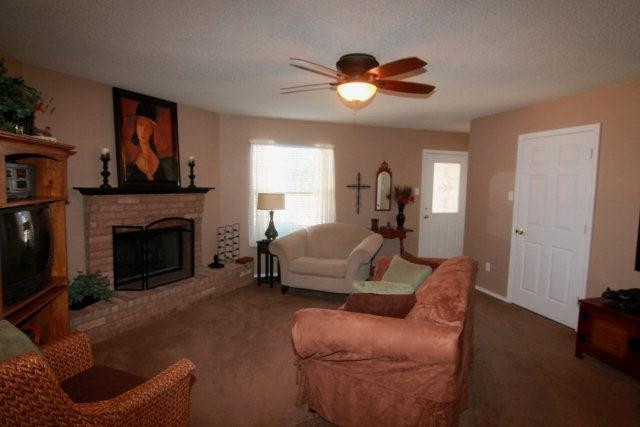 2525 110th Street Lubbock, TX 79423 - Photo 4 of 10 a living room with furniture and a fireplace