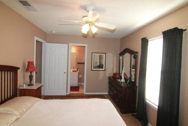 2525 110th Street Lubbock, TX 79423 - Photo 9 of 10 a bedroom with a bed and a chandelier