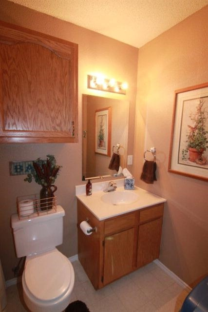 2525 110th Street Lubbock, TX 79423 - Photo 10 of 10 a bathroom with a toilet sink and mirror