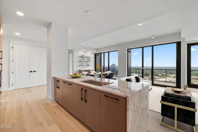 a kitchen with sink and large window