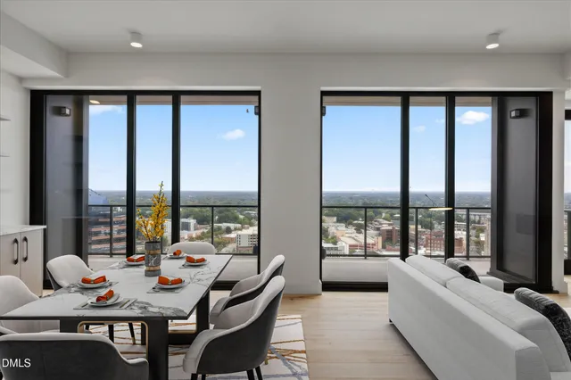 a living room with furniture and large windows