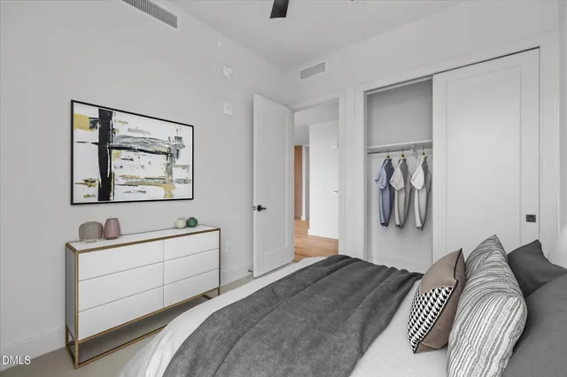 a bedroom with a bed and a painting on the wall