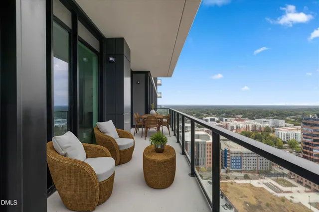 a balcony with furniture and a potted plant