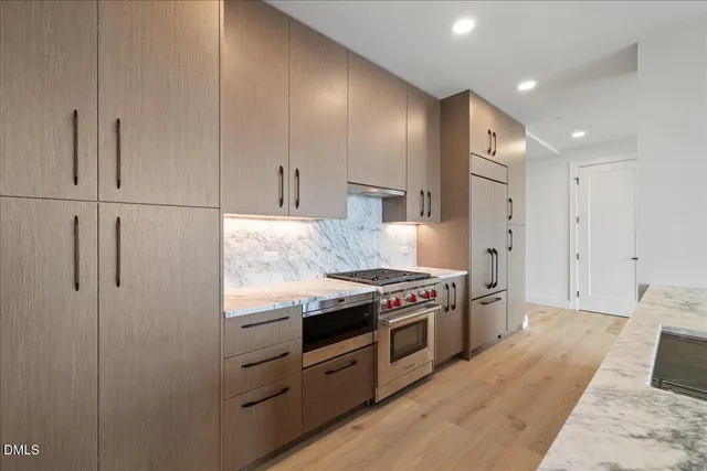 a kitchen with stainless steel appliances granite countertop a stove a refrigerator and a refrigerator