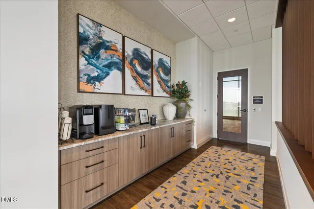 a living room with furniture a flat screen tv and a large window