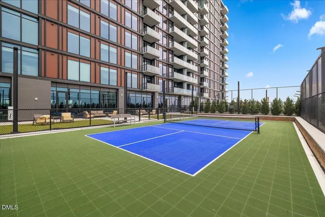 a kitchen with stainless steel appliances kitchen island granite countertop a table and chairs in it
