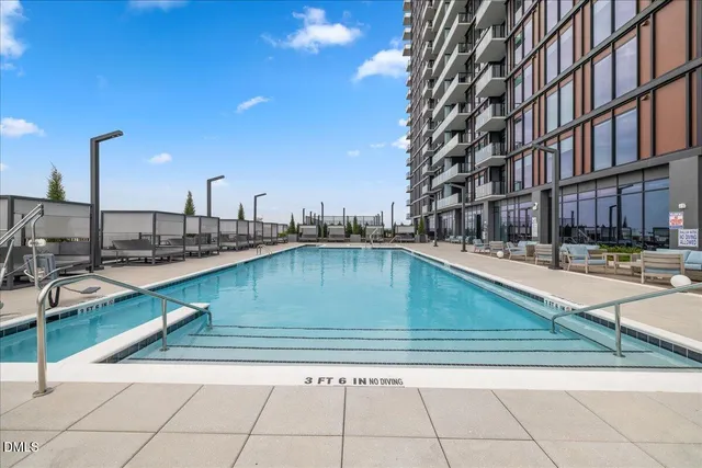 a living room with lots of furniture and a chandelier