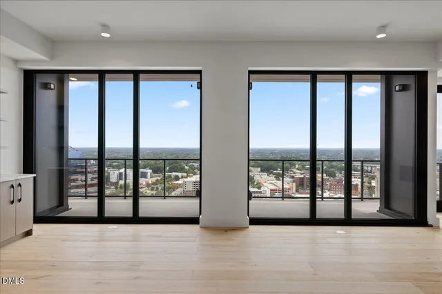 a view of an empty room with windows and mountain view