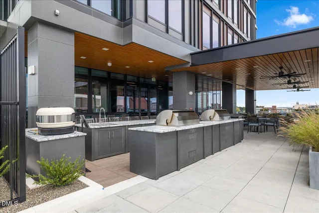 a view of a swimming pool with a patio and a yard