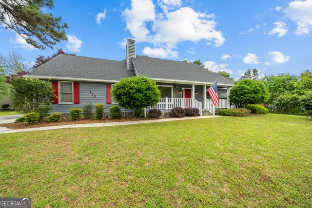 a front view of house with yard and green space