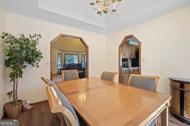 a view of a dining room with furniture and wooden floor