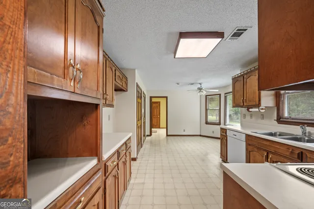 a kitchen with a stove a sink and cabinets