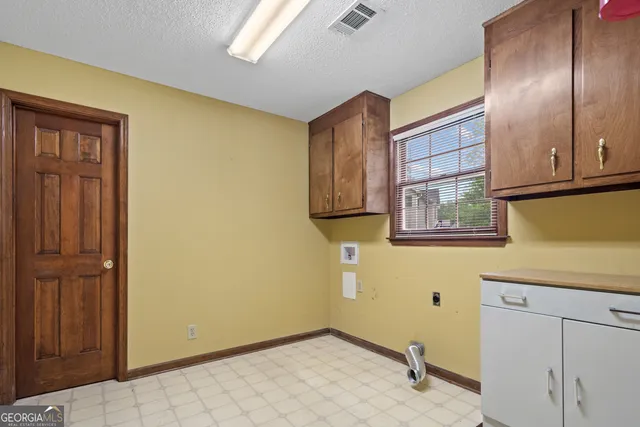 a bedroom that has a bed and a desk in it