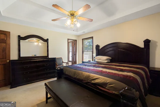 an empty room with closet and a chandelier fan