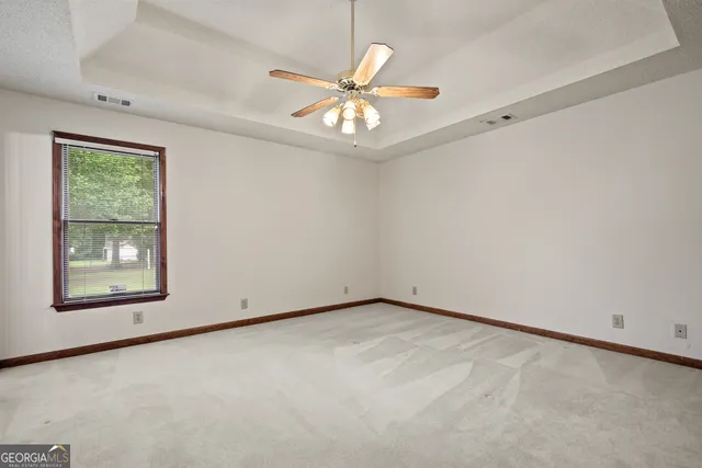 a view of a hallway with closet and a mirror