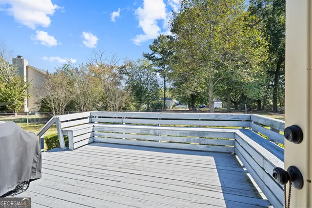 a front view of house with yard and trees in the background
