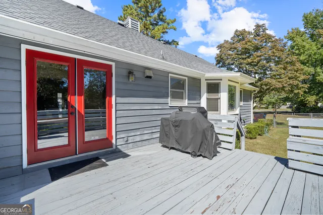 a view of a house with a big yard and large trees
