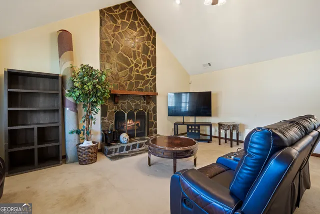 a living room with fireplace furniture and a flat screen tv