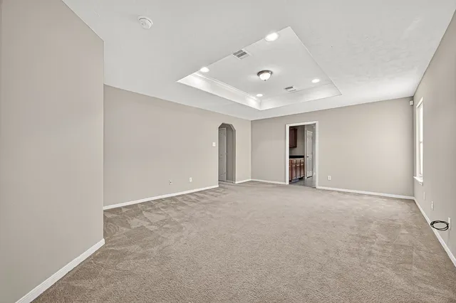 an empty room with a empty space and windows