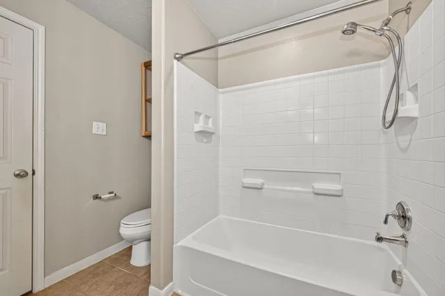 a bathroom with a toilet and a bathtub