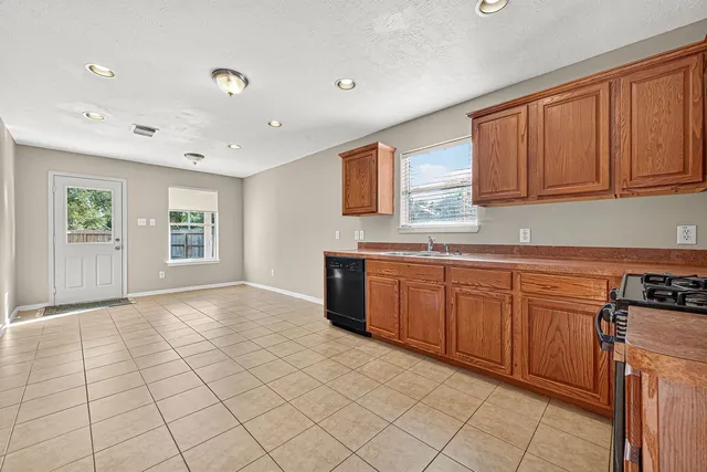 a kitchen with stainless steel appliances granite countertop a stove sink and cabinets