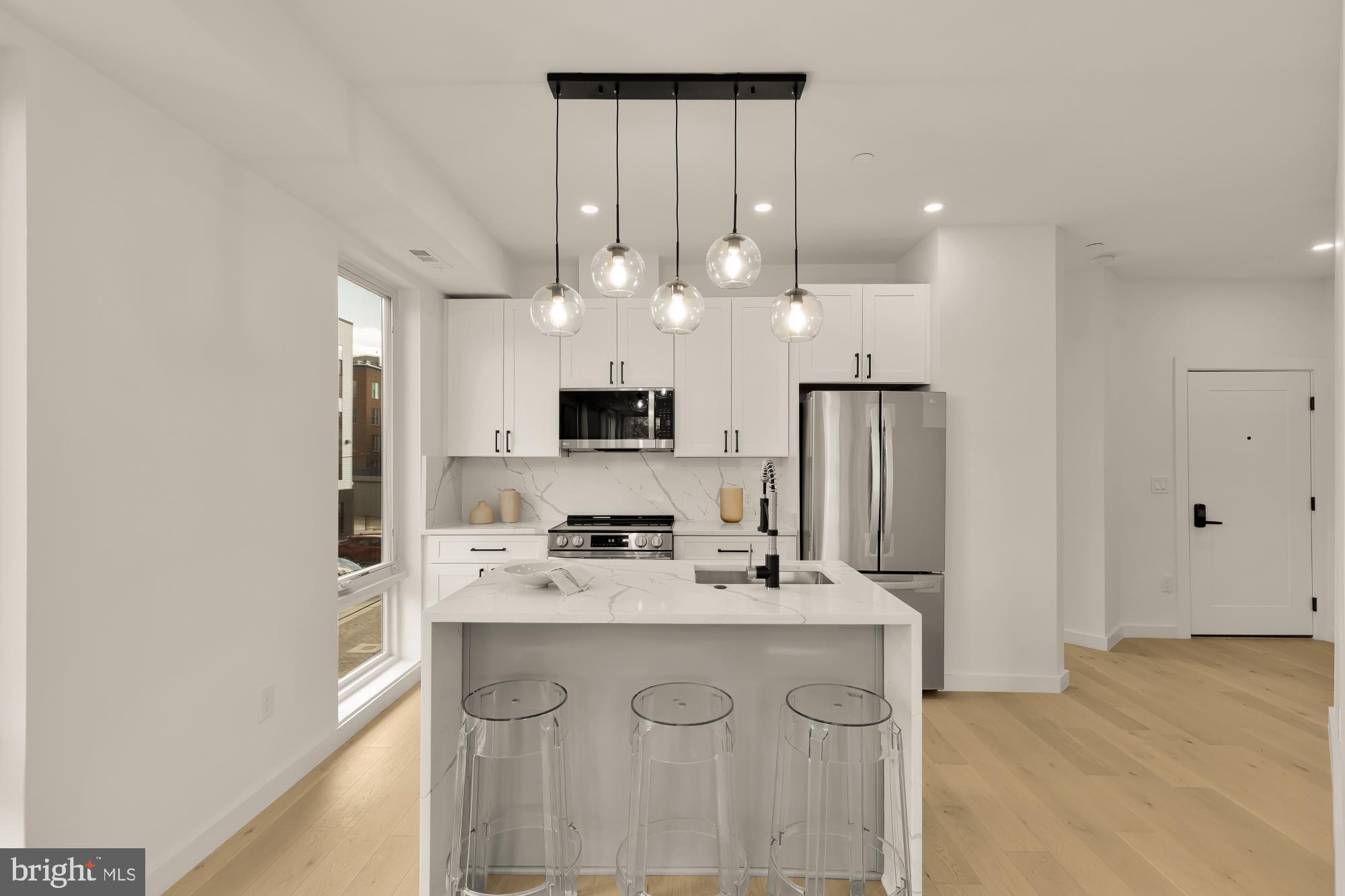 30 Kennedy Street Northwest, Unit 6 Washington, DC 20011 - Photo 11 of 35 a kitchen with kitchen island a sink stainless steel appliances and cabinets