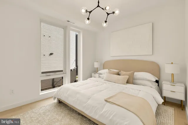 a bedroom with a bed and a night stand