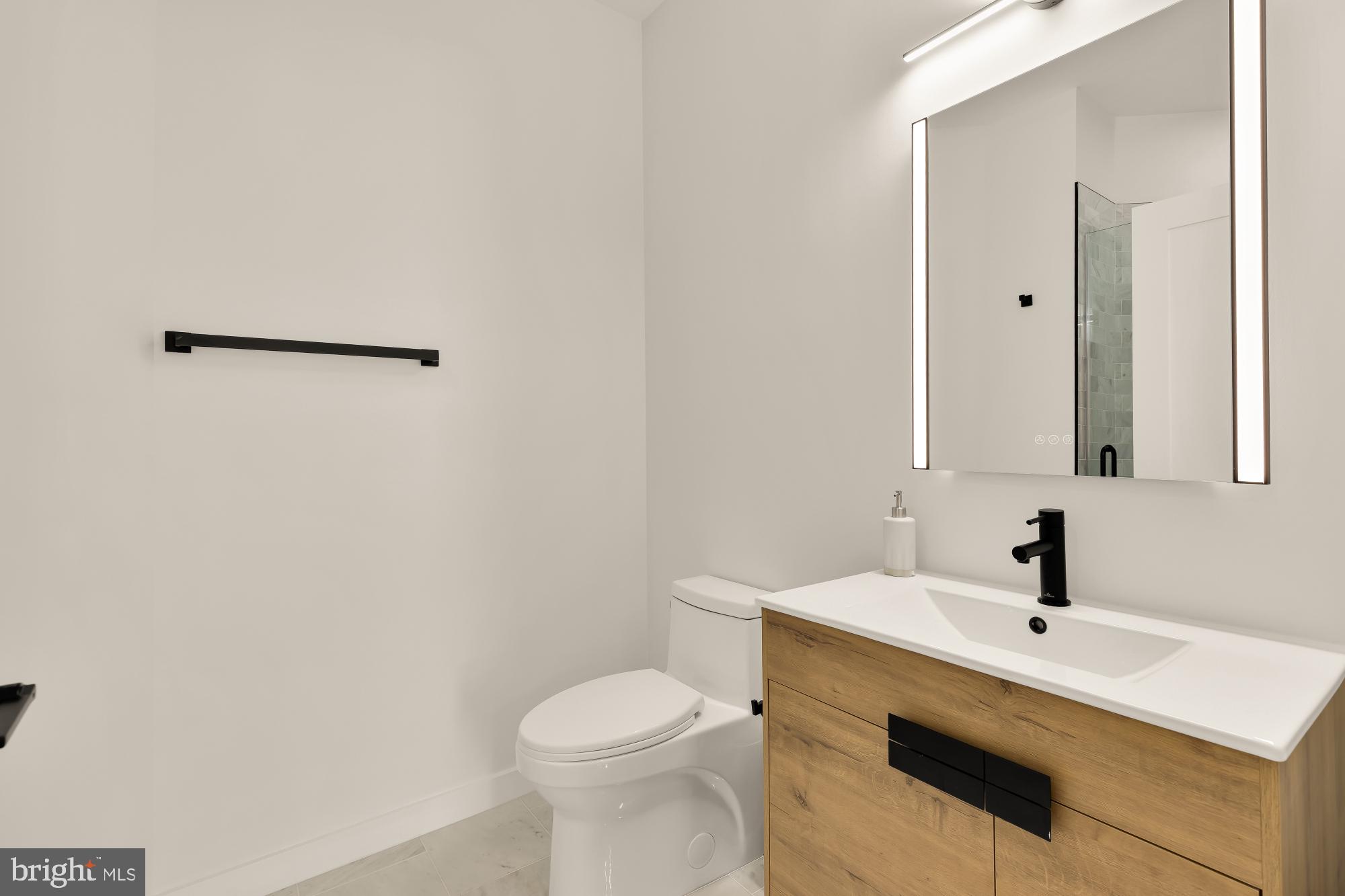 30 Kennedy Street Northwest, Unit 6 Washington, DC 20011 - Photo 24 of 35 a bathroom with a sink a toilet and mirror