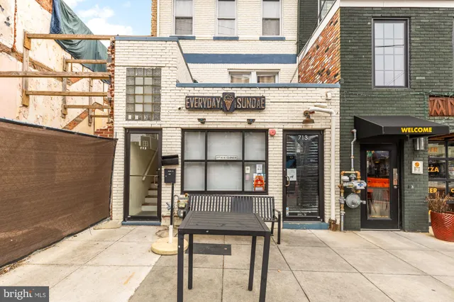 a picture of a bench in front of a building