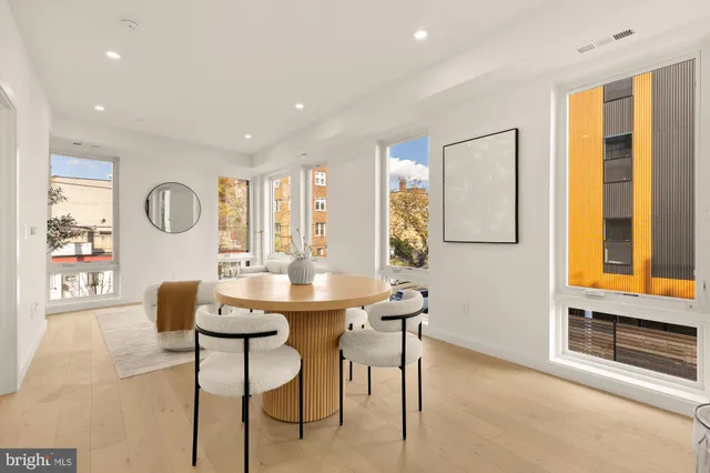 a dining room with furniture and a window