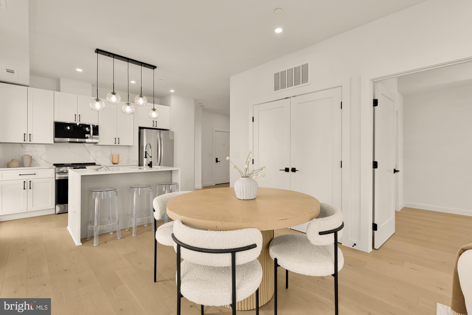 30 Kennedy Street Northwest, Unit 6 Washington, DC 20011 - Photo 8 of 35 a kitchen with kitchen island a stove a table and chairs in it
