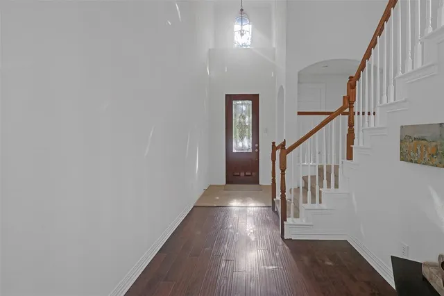 a view of entryway and hall with wooden floor