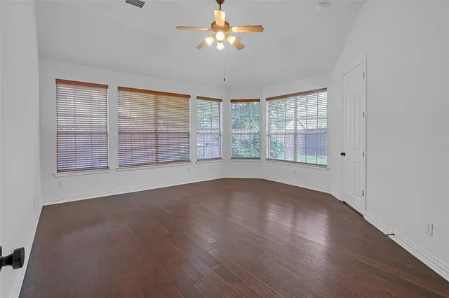 wooden floor in an empty room with a window
