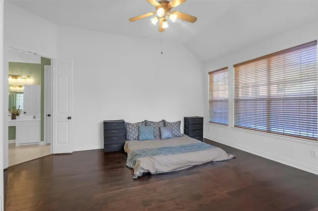 a bedroom with a large bed and a chandelier