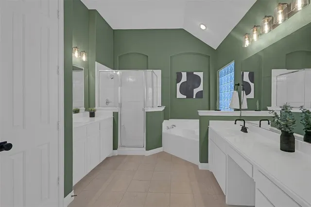 a bathroom with a double vanity sink mirror and shower