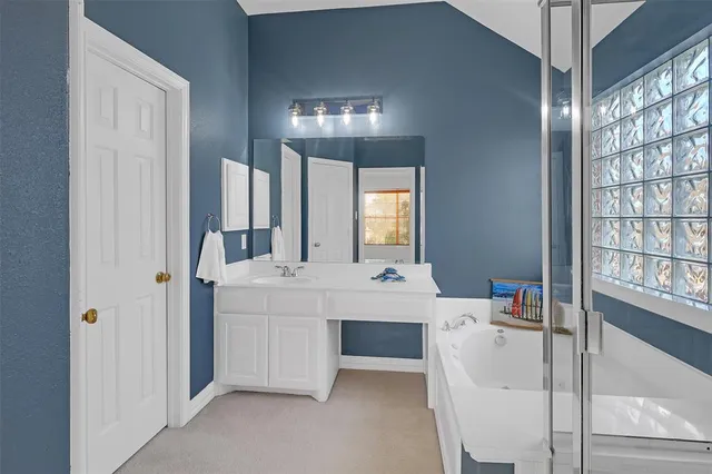 a view of hall way with furniture and chandelier