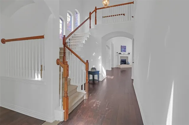 a view of entryway and hall with wooden floor