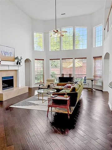 a living room with furniture fireplace and window