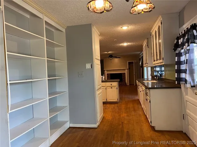 a kitchen with cabinets and wooden floor