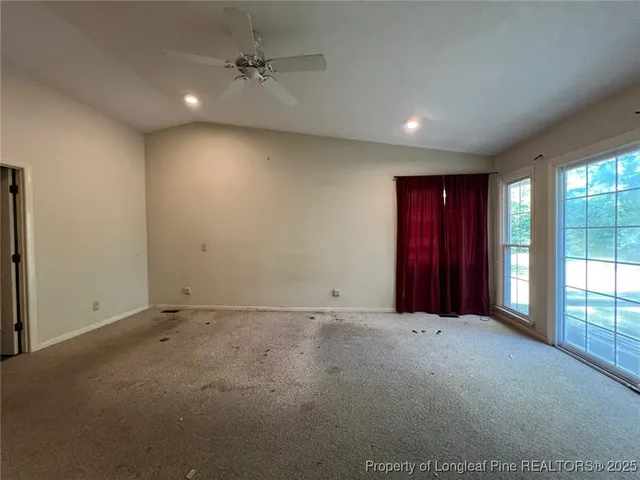an empty room with windows and closet