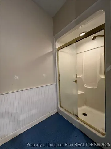 a bathroom with a glass shower door