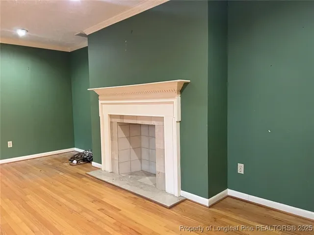 a room with a fireplace and wooden floor