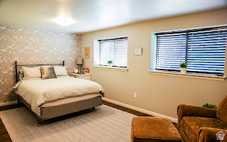 578 High Bench Road Alpine, UT 84004 - Photo 36 of 39 Bedroom featuring a patterned accent wall, two distinct windows with blinds, dark wood-finish flooring, and a flush-mount ceiling light